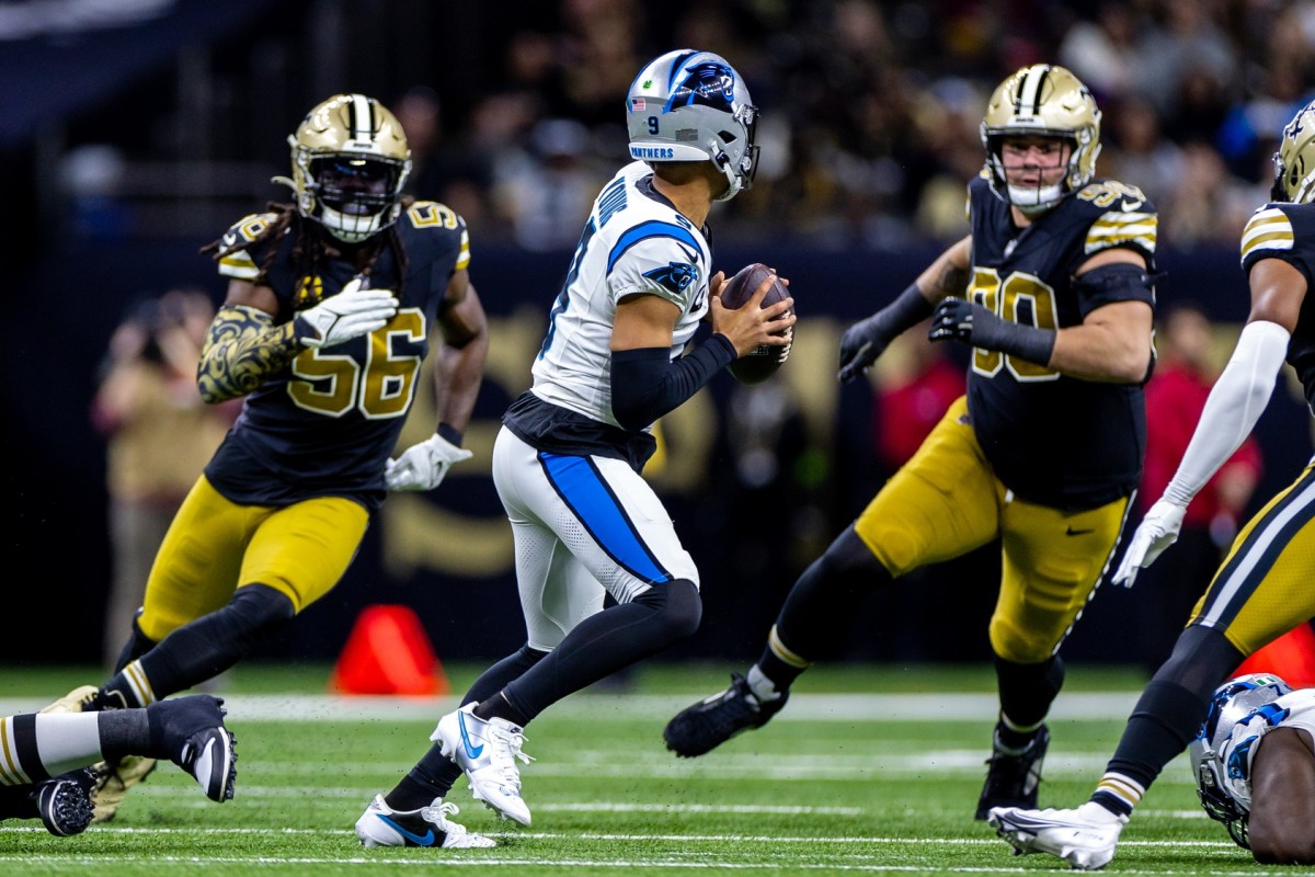 Carolina Panthers quarterback Bryce Young (9) is chased out the pocket by New Orleans Saints linebacker Demario Davis (56) and defensive tackle Bryan Bresee (90). Mandatory Credit: Stephen Lew-USA TODAY Sports