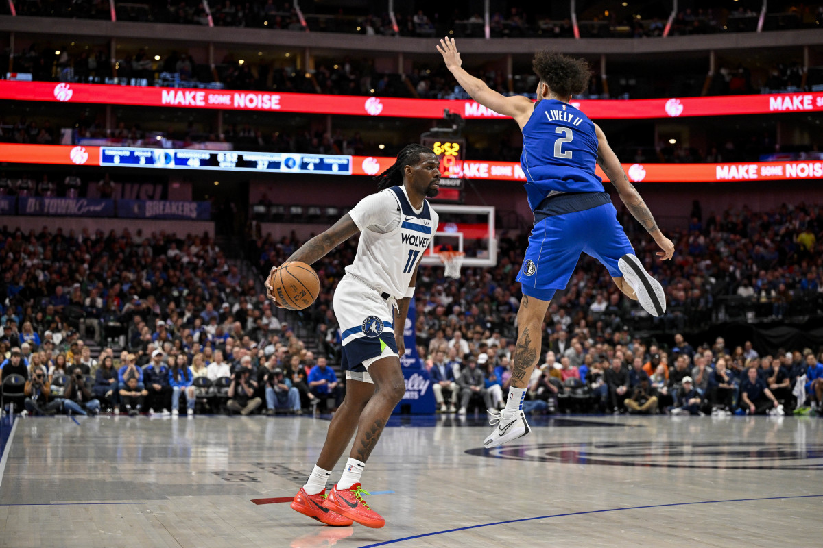 Dec 14, 2023; Dallas, Texas, USA; Minnesota Timberwolves center Naz Reid (11) avoids a leaping Dallas Mavericks center Dereck Lively II (2) during the second quarter at the American Airlines Center.