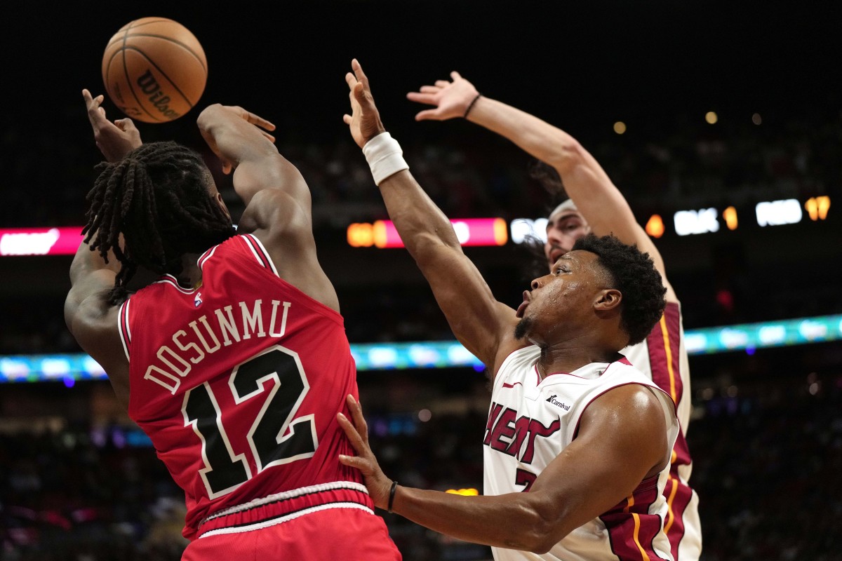 Miami Heat guard Kyle Lowry (7) forces Chicago Bulls guard Ayo Dosunmu (12) to alter his shot during the first half at Kaseya Center.