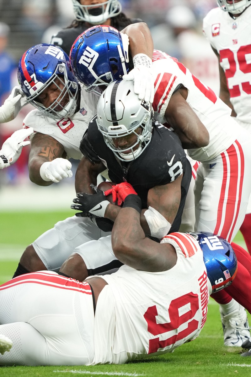 November 5, 2023; Las Vegas Raiders running back Josh Jacobs (8) is tackled by New York Giants defensive tackle Dexter Lawrence II (97), cornerback Deonte Banks (25), and defensive tackle A'Shawn Robinson (91). Mandatory Credit: Kyle Terada-USA TODAY