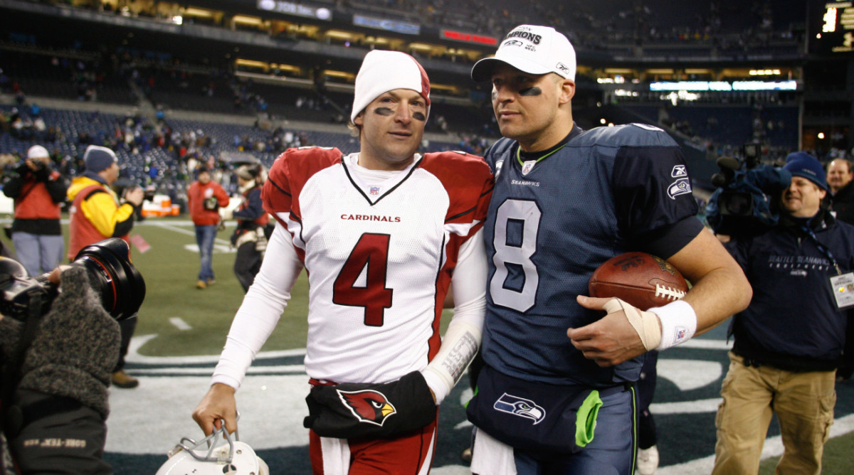 Quarterback brothers Tim and Matt Hasselbeck talk after a game between the Cardinals and Seahawks.