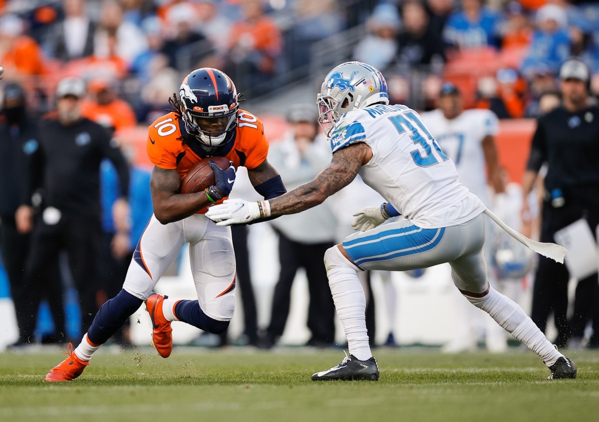 Denver Broncos wide receiver Jerry Jeudy (10) runs the ball as Detroit Lions safety Dean Marlowe (31) defends in the third quarter at Empower Field at Mile High.