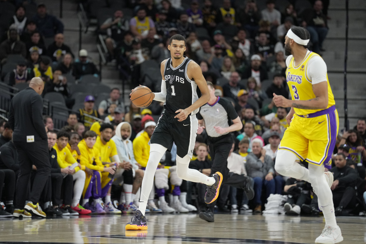 Dec 13, 2023; San Antonio, Texas, USA; San Antonio Spurs center Victor Wembanyama (1) dribbles the ball in front of Los Angeles Lakers forward Anthony Davis (3) in the first quarter at the Frost Bank Center.