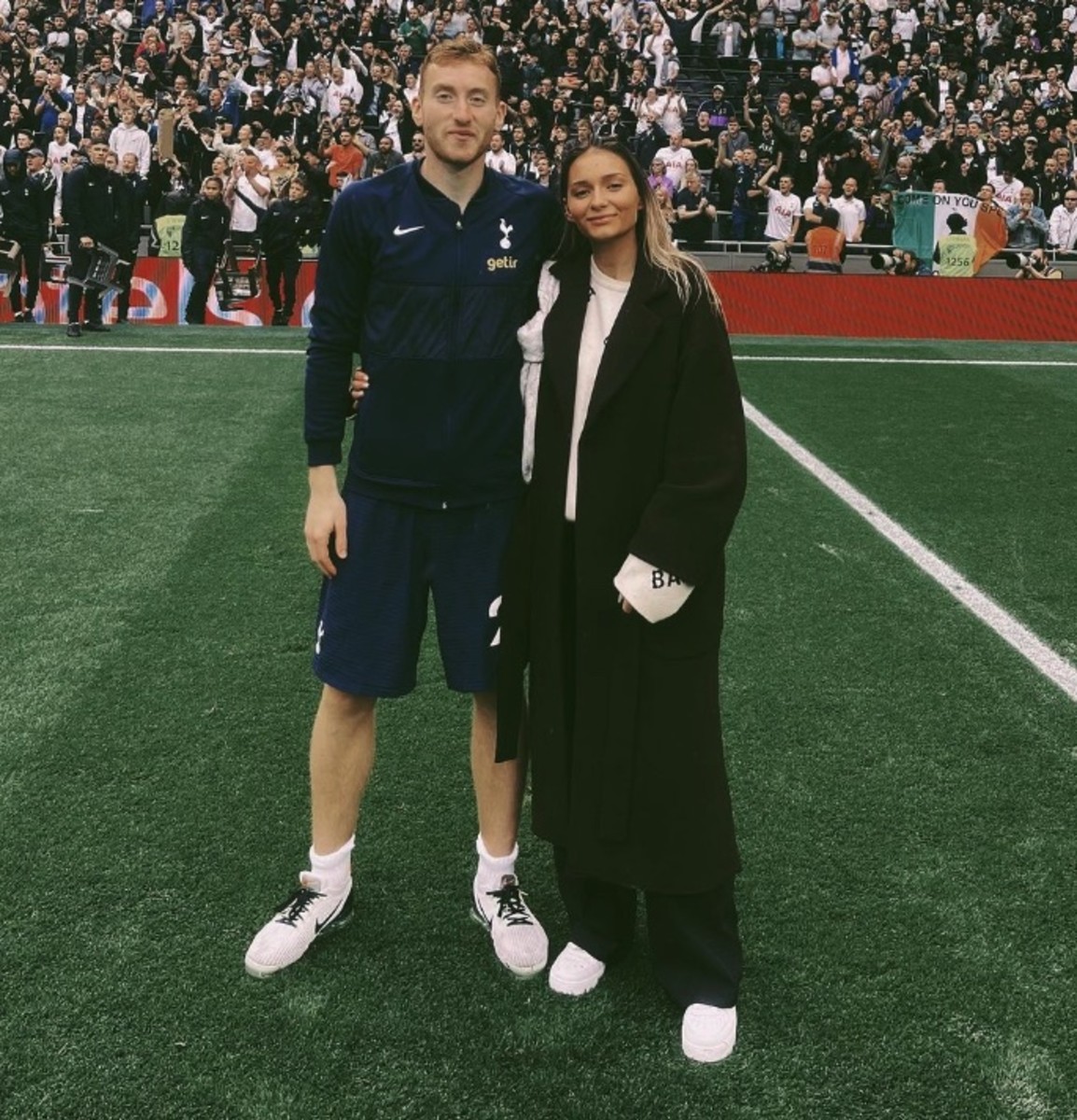 Dejan Kulusevski pictured with girlfriend Eldina Ahmic on the pitch at Tottenham Hotspur Stadium after a Premier League game against Burnley in May 2022