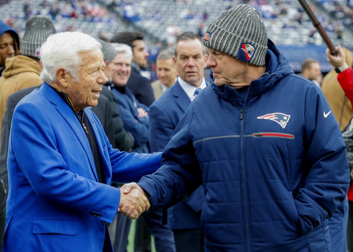 New England Patriots owner Robert Kraft (left) shares a pregame handshake with coach Bill Belichick.