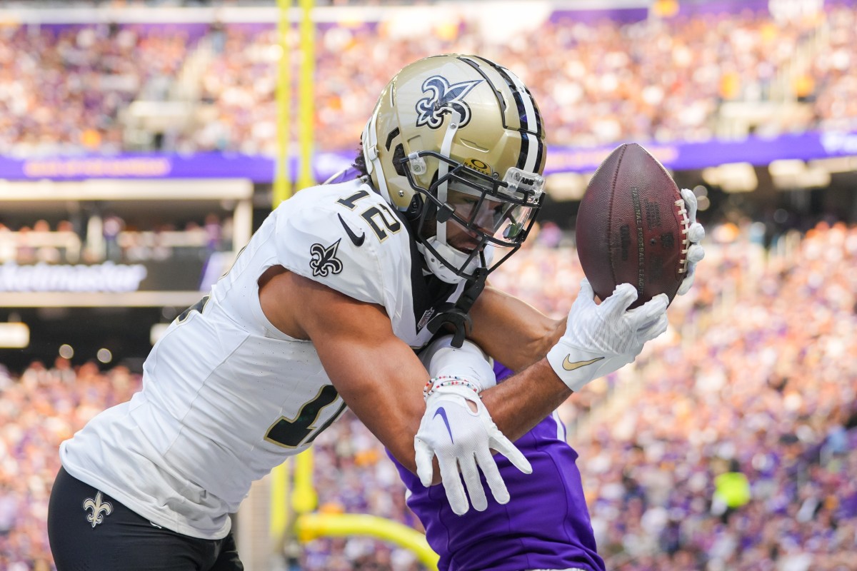 New Orleans Saints wide receiver Chris Olave (12) catches a touchdown pass against the Minnesota Vikings. Mandatory Credit: Brad Rempel-USA TODAY Sports