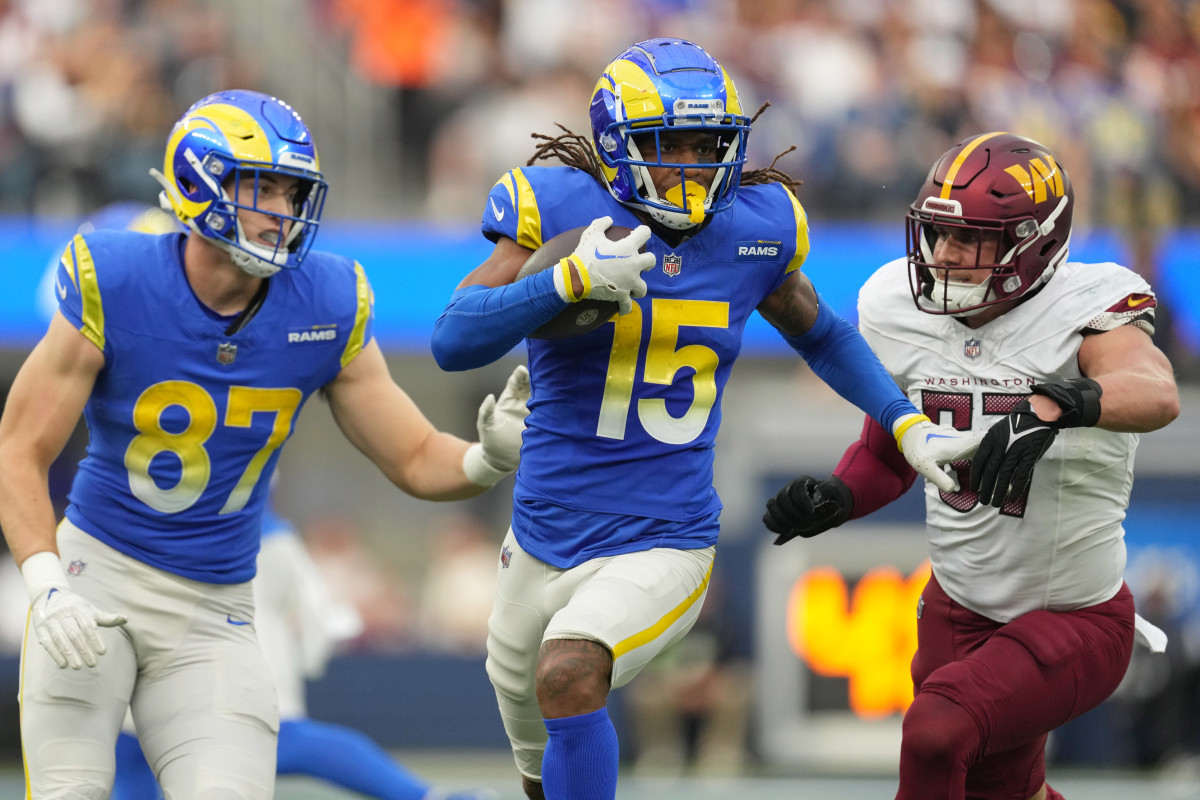 Los Angeles Rams wide receiver Demarcus Robinson (15) carries the ball against Washington Commanders cornerback Nick Whiteside II (37) in the first half at SoFi Stadium.
