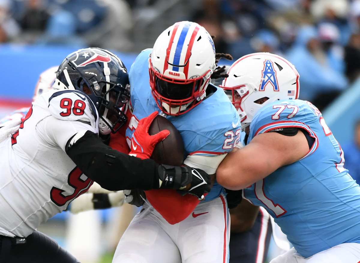 Tennessee Titans running back Derrick Henry (22) is tackled by Houston Texans defensive tackle Sheldon Rankins (98) during the second half at Nissan Stadium.