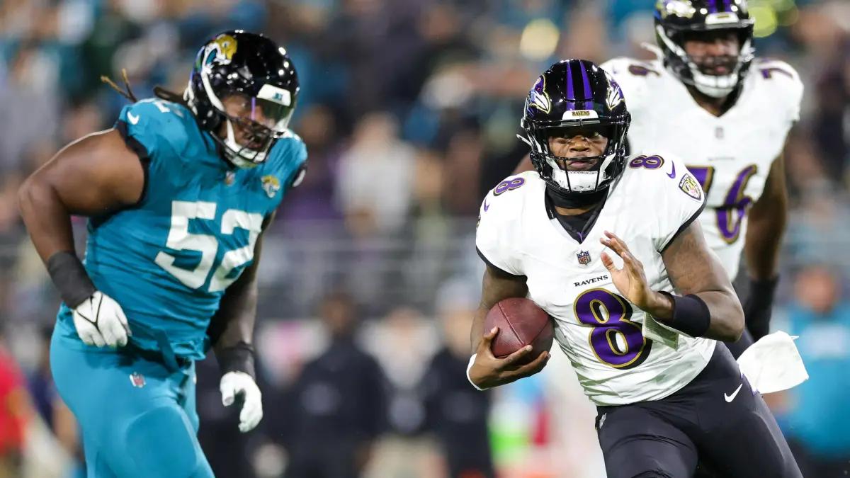Ravens quarterback Lamar Jackson eludes Jaguars defenders on Sunday night.