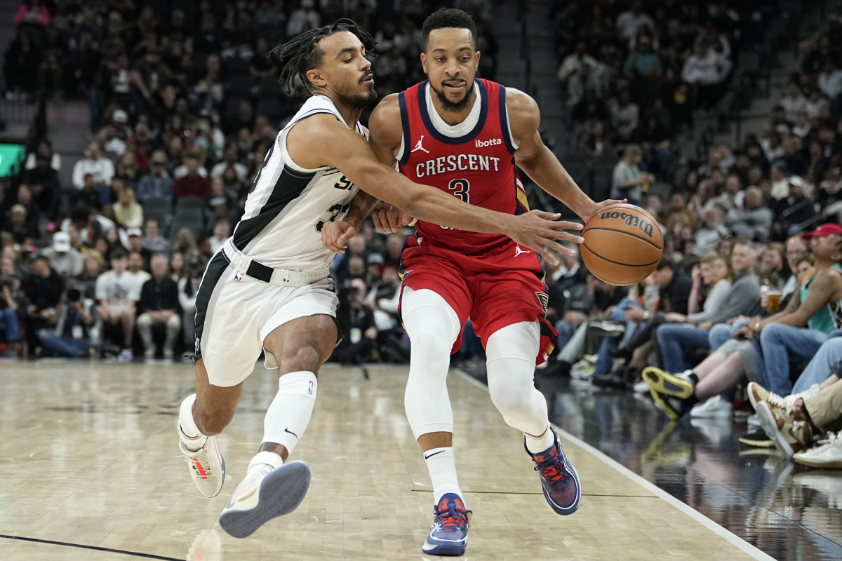 Dec 17, 2023; San Antonio, Texas, USA; New Orleans Pelicans CJ McCollum (3) dribbles while defended by San Antonio Spurs guard Tre Jones (33) during the first half at Frost Bank Center.
