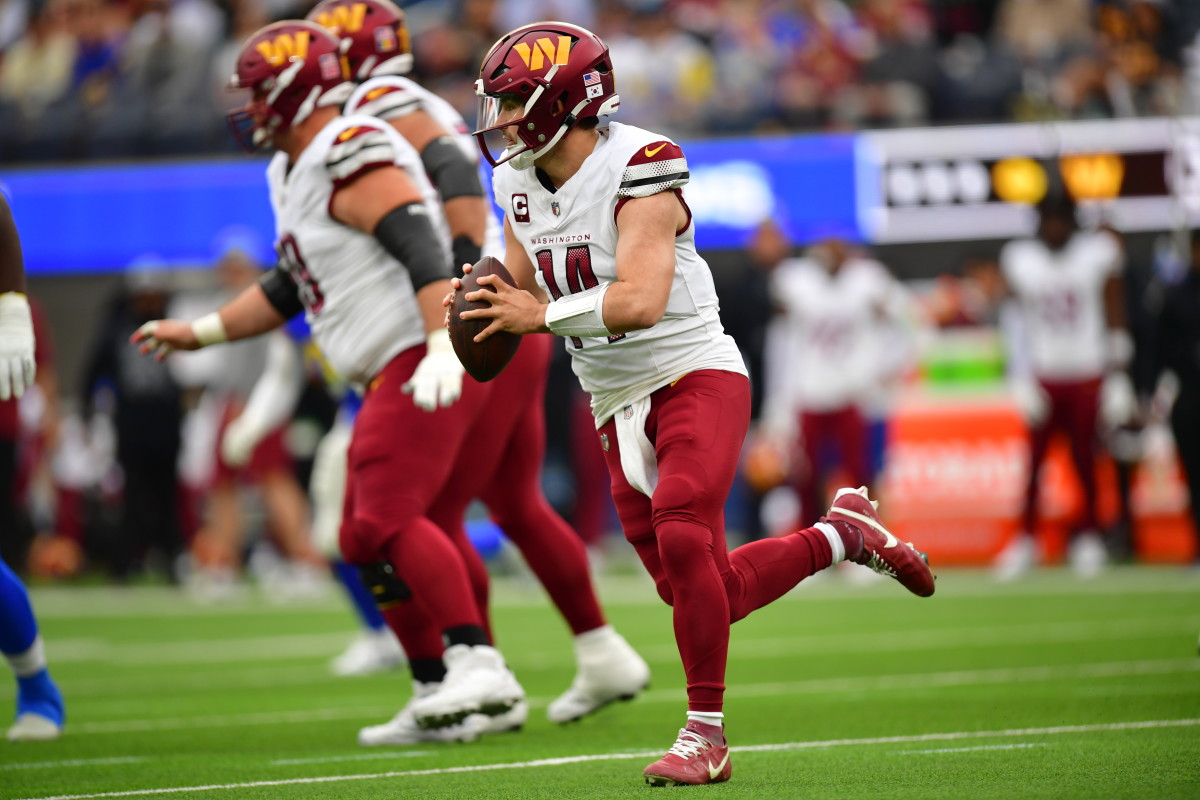 Dec 17, 2023; Inglewood, California, USA; Washington Commanders quarterback Sam Howell (14) moves out to pass against the against the Los Angeles Rams during the first half at SoFi Stadium.