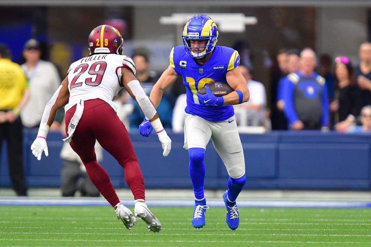 Los Angeles Rams wide receiver Cooper Kupp (10) runs the ball against Washington Commanders cornerback Kendall Fuller (29) during the first half at SoFi Stadium.