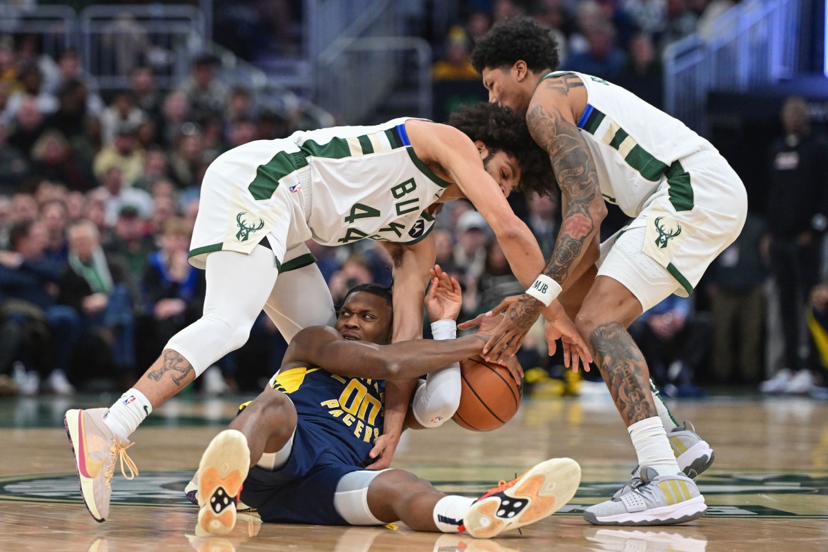 Indiana Pacers center Bennedict Mathurin (00) battles for a loose ball against Milwaukee Bucks guard Andre Jackson Jr. (44)  with MarJon Beauchamp