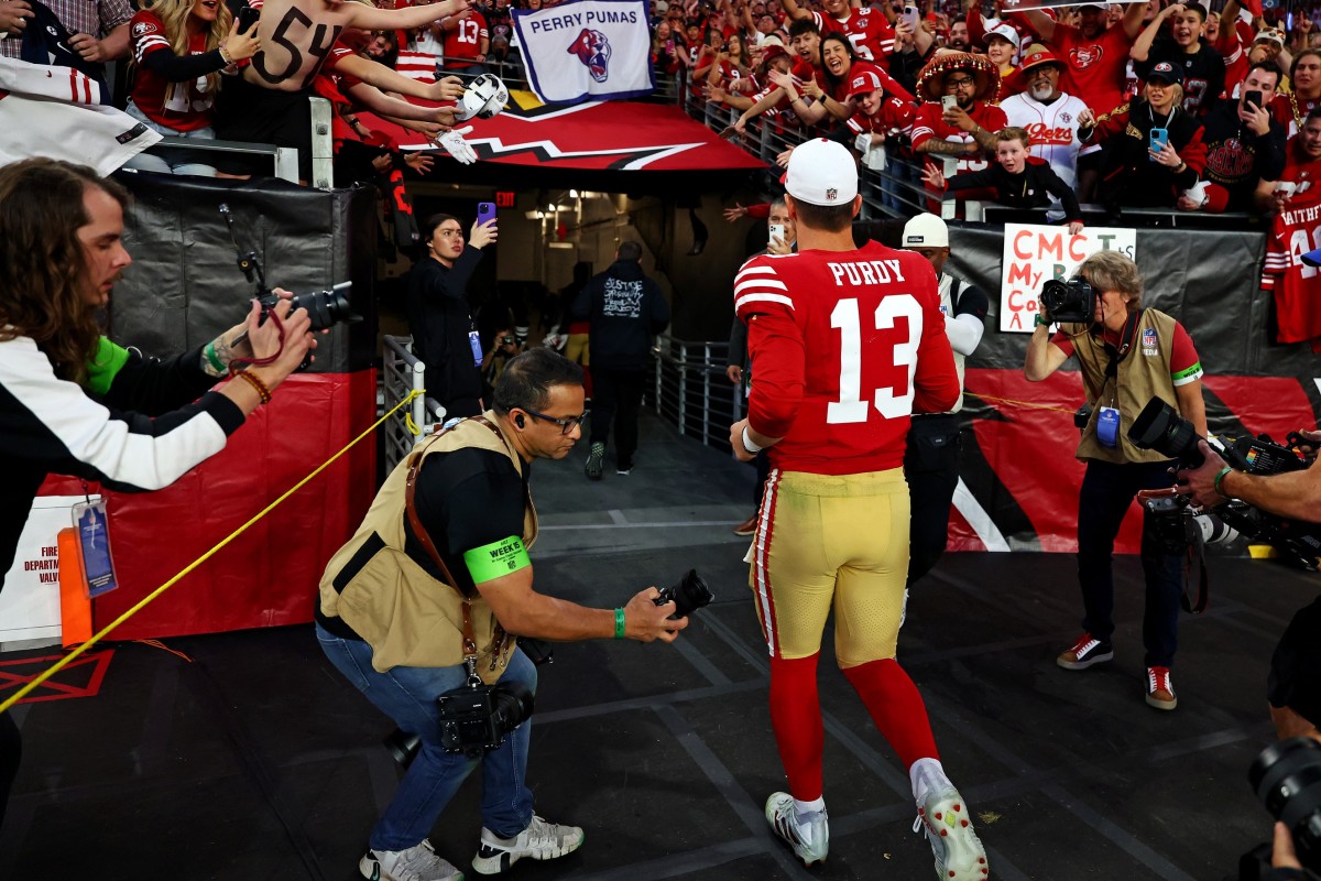 San Francisco quarterback Brock Purdy exits the field cheered on by fans from his hometown and 49ers fans after his team's rout of the Cardinals in Week 15.