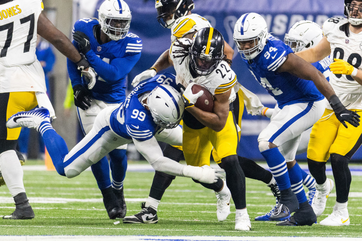 Dec 16, 2023; Indianapolis, Indiana, USA; Pittsburgh Steelers running back Najee Harris (22) runs the ball while Indianapolis Colts defensive tackle DeForest Buckner (99) defends in the second half at Lucas Oil Stadium. Mandatory Credit: Trevor Ruszkowski-USA TODAY Sports