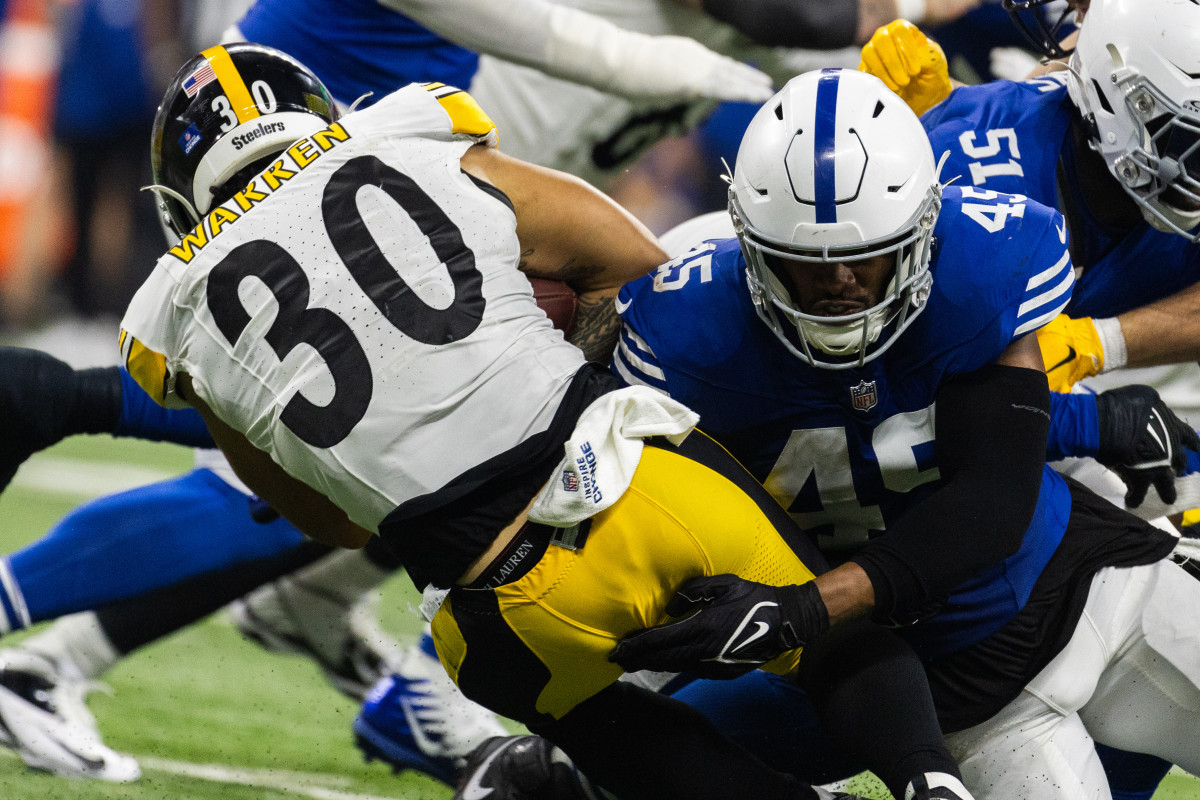 Dec 16, 2023; Indianapolis, Indiana, USA; Pittsburgh Steelers running back Jaylen Warren (30) runs the ball while Indianapolis Colts linebacker E.J. Speed (45) defends in the first half at Lucas Oil Stadium. Mandatory Credit: Trevor Ruszkowski-USA TODAY Sports