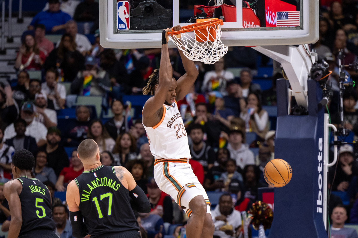 Dec 1, 2023; New Orleans, Louisiana, USA; San Antonio Spurs center Charles Bassey (28) dunks the ball against New Orleans Pelicans center Jonas Valanciunas (17) during the first half at the Smoothie King Center.