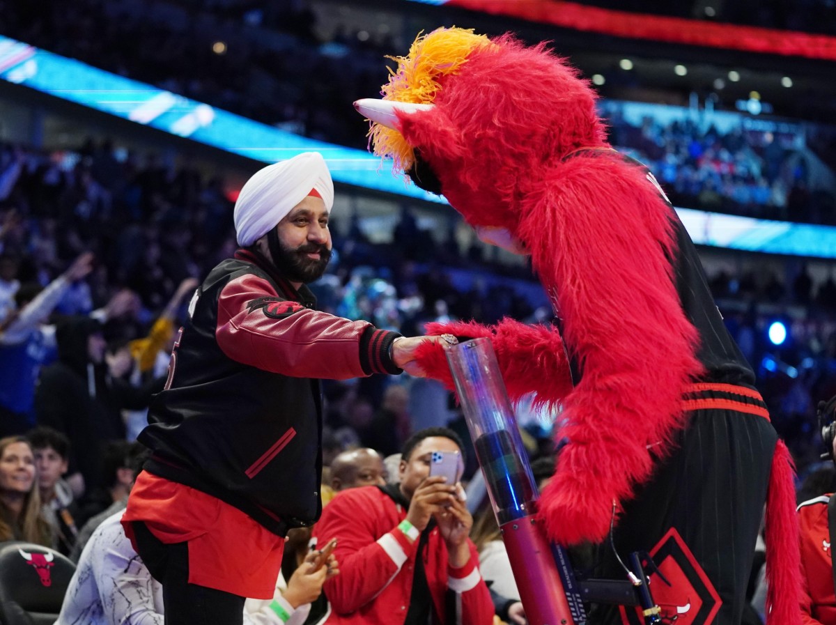 Chicago Bulls mascot greets Toronto Raptors fan Nav Bhatia during the NBA Rising Stars basketball game at United Center.