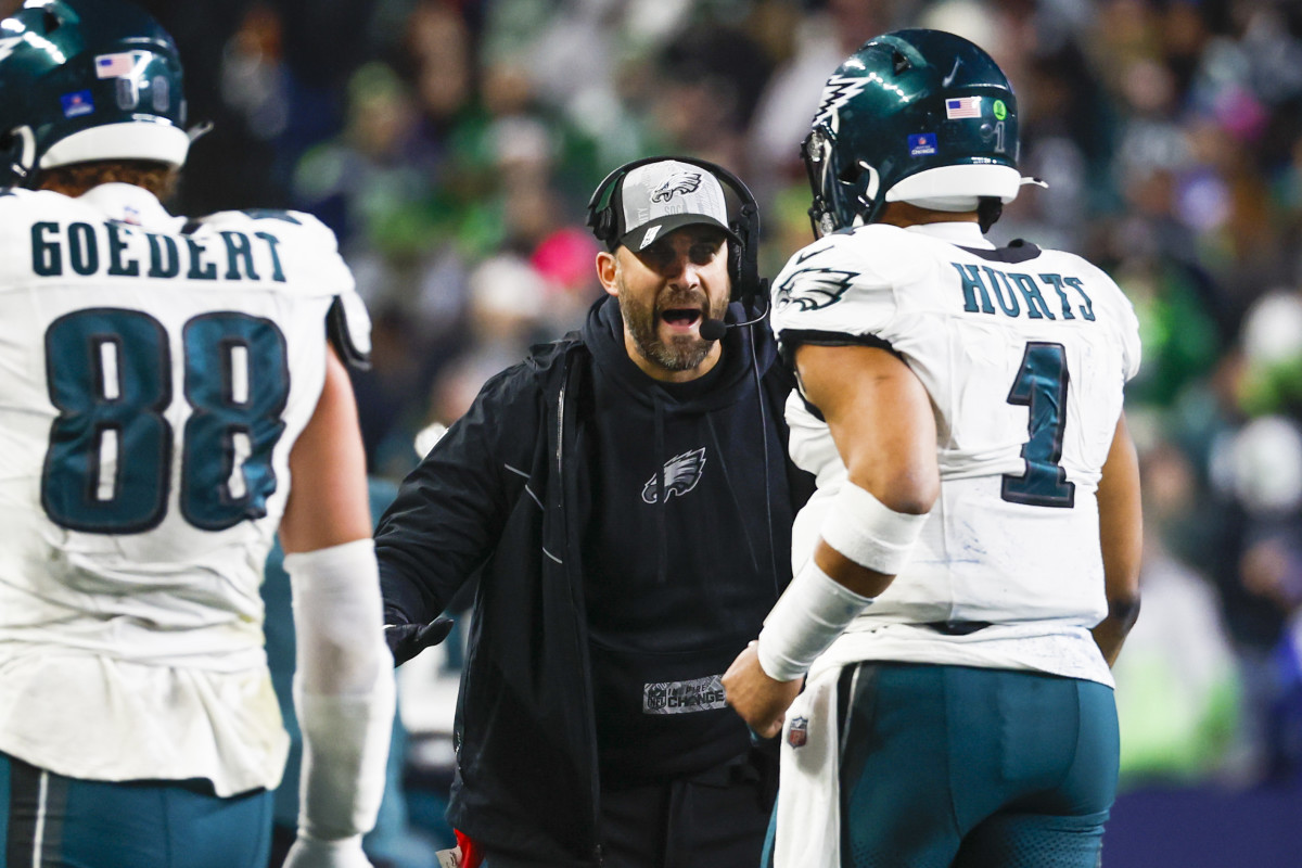 Philadelphia Eagles head coach Nick Sirianni greets quarterback Jalen Hurts following a touchdown against the Seattle Seahawks during the third quarter at Lumen Field.