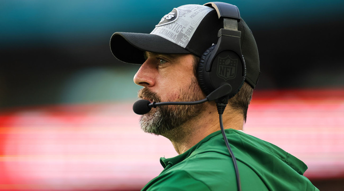 Jets quarterback Aaron Rodgers stands on the sidelines.