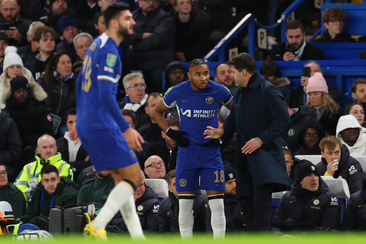 Christopher Nkunku pictured (center) receiving instructions from manager Mauricio Pochettino moments before making his Chelsea debut in an EFL Cup quarter-final against Newcastle in December 2023