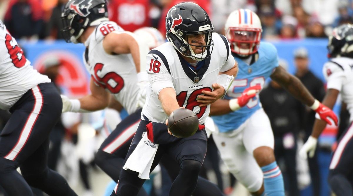 Texans quarterback Case Keenum hands the ball off during a game against the Titans.
