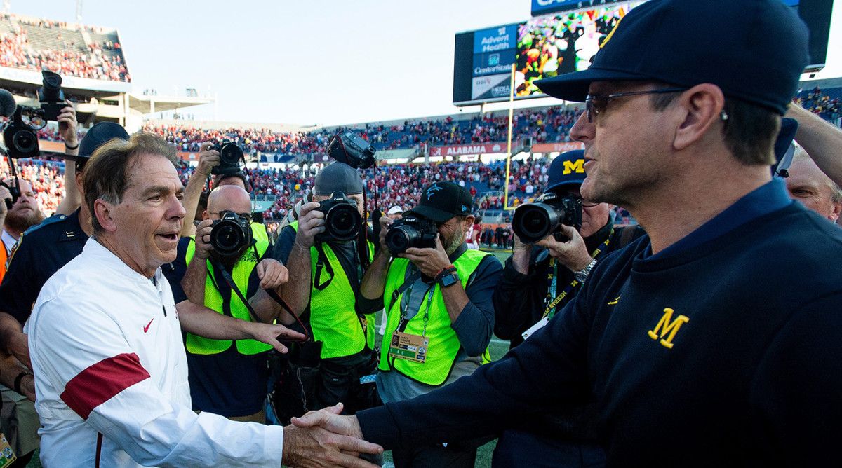 Alabama coach Nick Saban greets Michigan coach Jim Harbaugh at midfield after the Citrus Bowl in Orlando.
