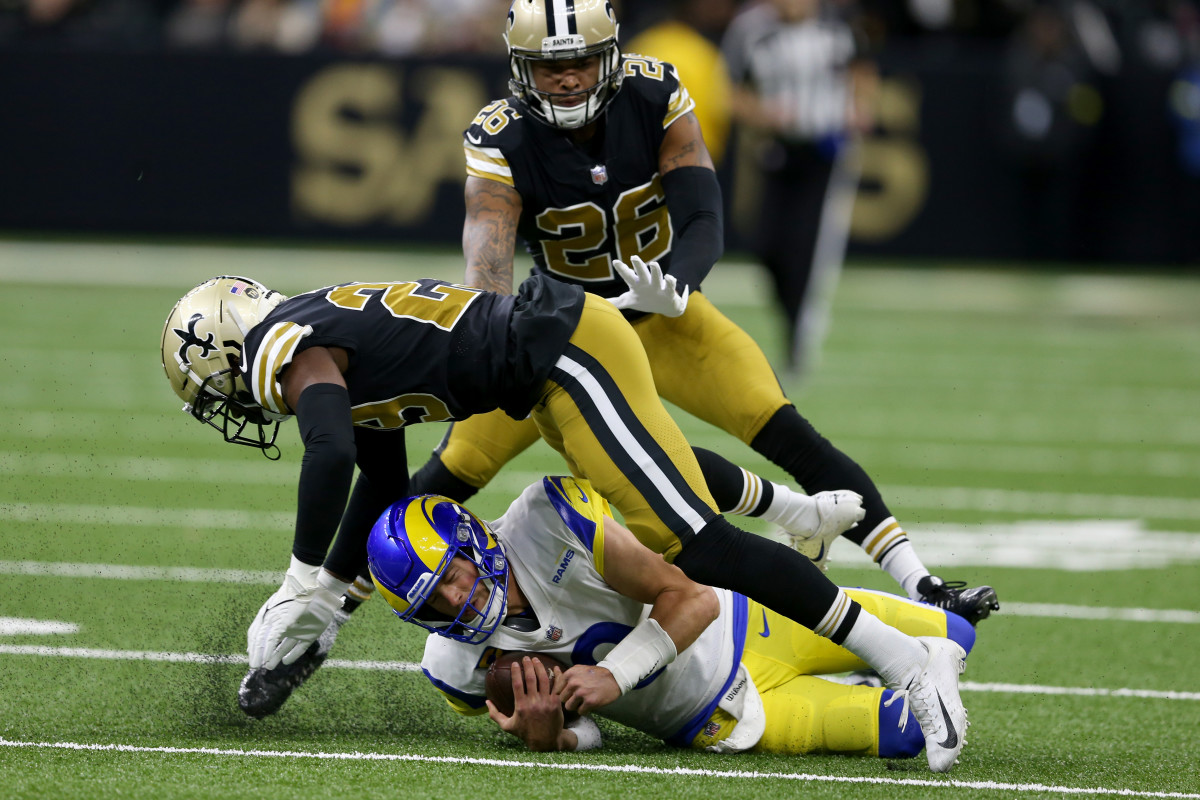 New Orleans, Louisiana, USA; Los Angeles Rams quarterback Matthew Stafford (9) slides under a tackle by New Orleans Saints cornerback Paulson Adebo (29)