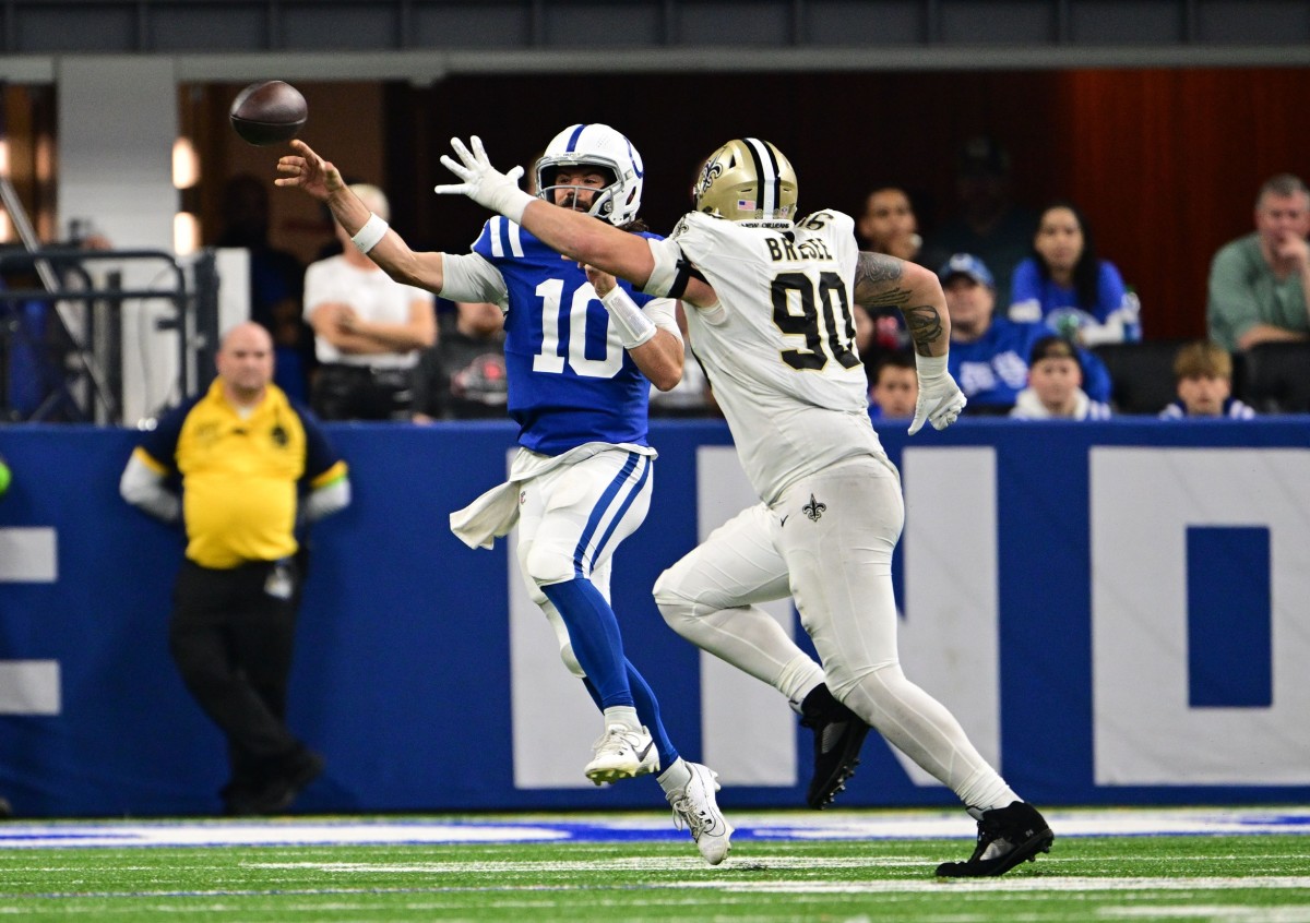 Oct 29, 2023; Indianapolis Colts quarterback Gardner Minshew (10) throws a pass under pressure from New Orleans Saints defensive tackle Bryan Bresee (90). Mandatory Credit: Marc Lebryk-USA TODAY Sports