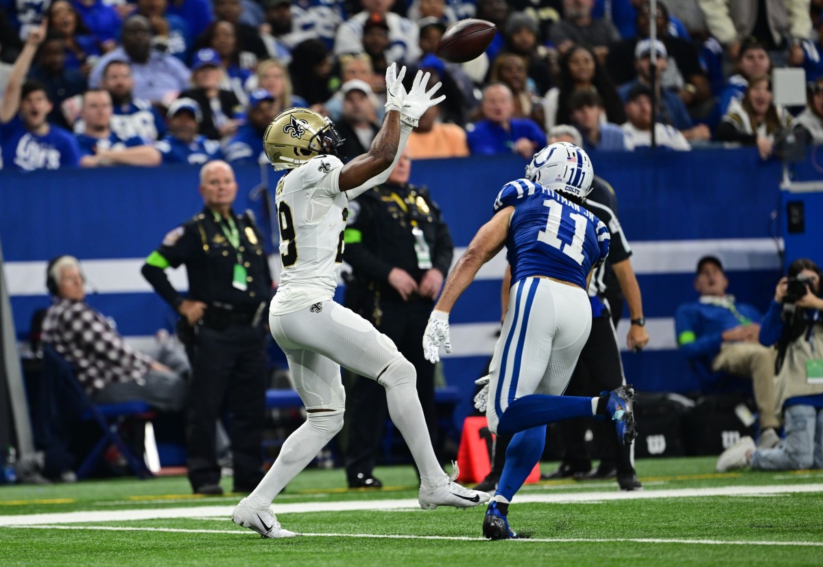Oct 29, 2023; New Orleans Saints cornerback Paulson Adebo (29) intercepts a pass for Indianapolis Colts receiver Michael Pittman Jr. (11). Mandatory Credit: Marc Lebryk-USA TODAY Sports