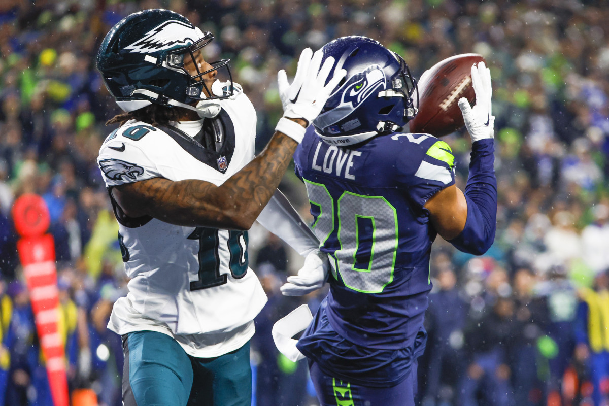 Seattle Seahawks safety Julian Love (20) intercepts a pass intended for Philadelphia Eagles wide receiver Quez Watkins (16) during the fourth quarter at Lumen Field. 
