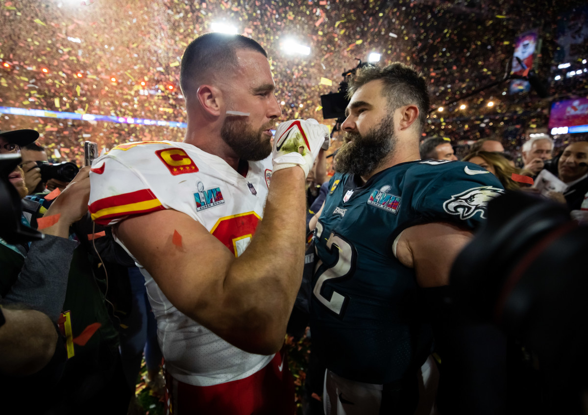 Jason Kelce and Travis Kelce face each other talking after the Super Bowl