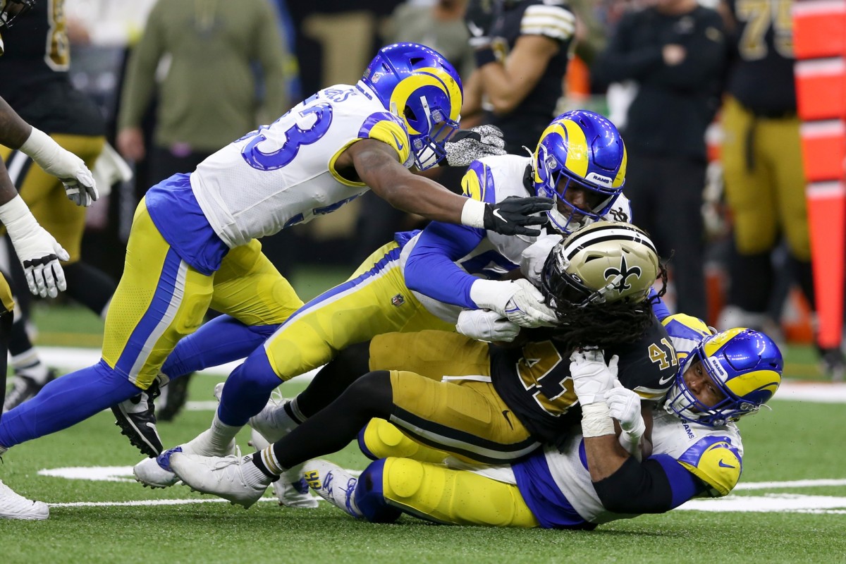 Nov 20, 2022; New Orleans Saints running back Alvin Kamara (41) is tackled by Los Angeles Rams defensive tackle Aaron Donald (99) and linebacker Ernest Jones (53). Mandatory Credit: Chuck Cook-USA TODAY Sports