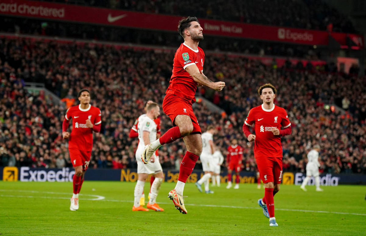 Dominik Szoboszlai pictured (center) celebrating after scoring a long-range goal for Liverpool against West Ham in an EFL Cup quarter-final at Anfield in December 2023