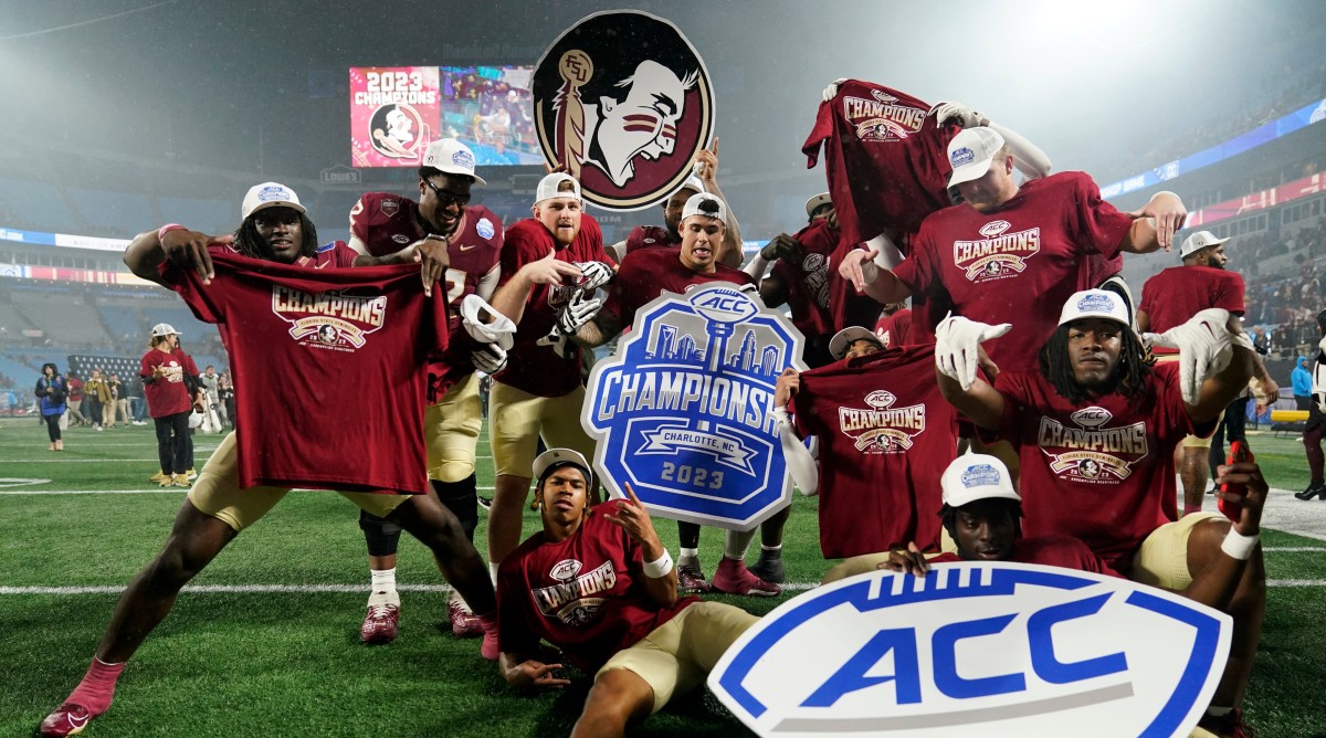 Florida State football players pose in celebration after winning the ACC championship.