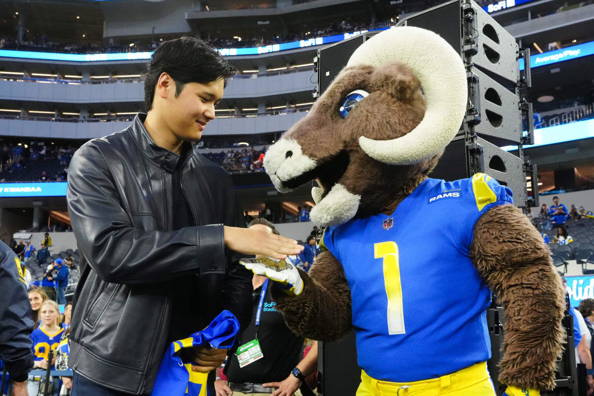 Dec 21, 2023; Inglewood, California, USA; Los Angeles Dodgers player Shohei Ohtani (left) shakes hands with Los Angeles Rams mascot Rampage at SoFi Stadium.