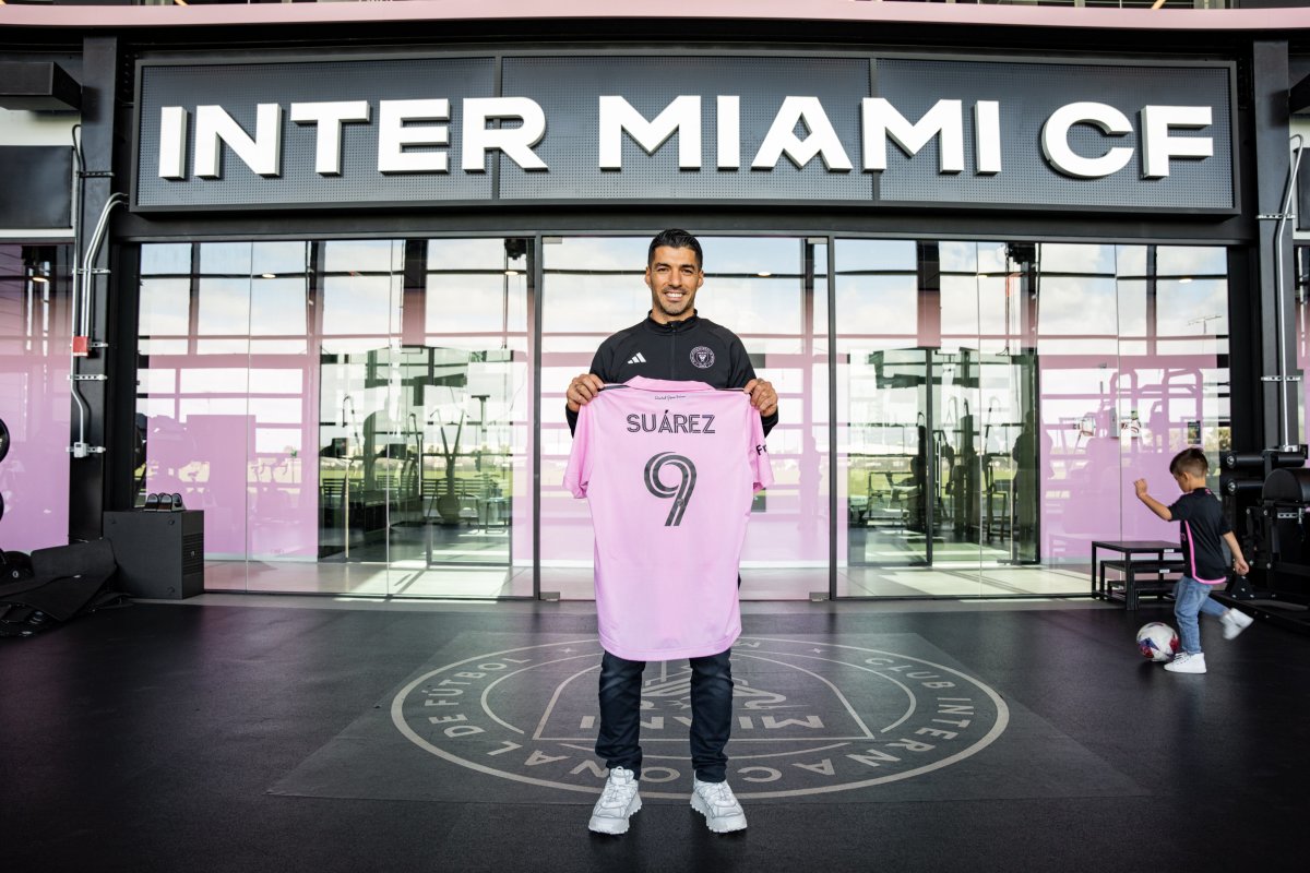 Luis Suarez pictured holding an Inter Miami jersey after signing for the Major League Soccer club ahead of the 2024 season