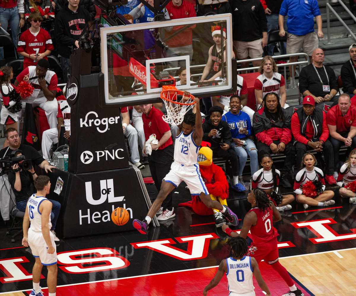 Kentucky's Antonio Reeves (12) dunked a lob from Reed Sheppard (15) as the Louisville Cardinals and the Kentucky Wildcats faced off in their annual rivalry matchup at the KFC Yum Center in downtown Louisville on Thursday, Dec. 21, 2023.