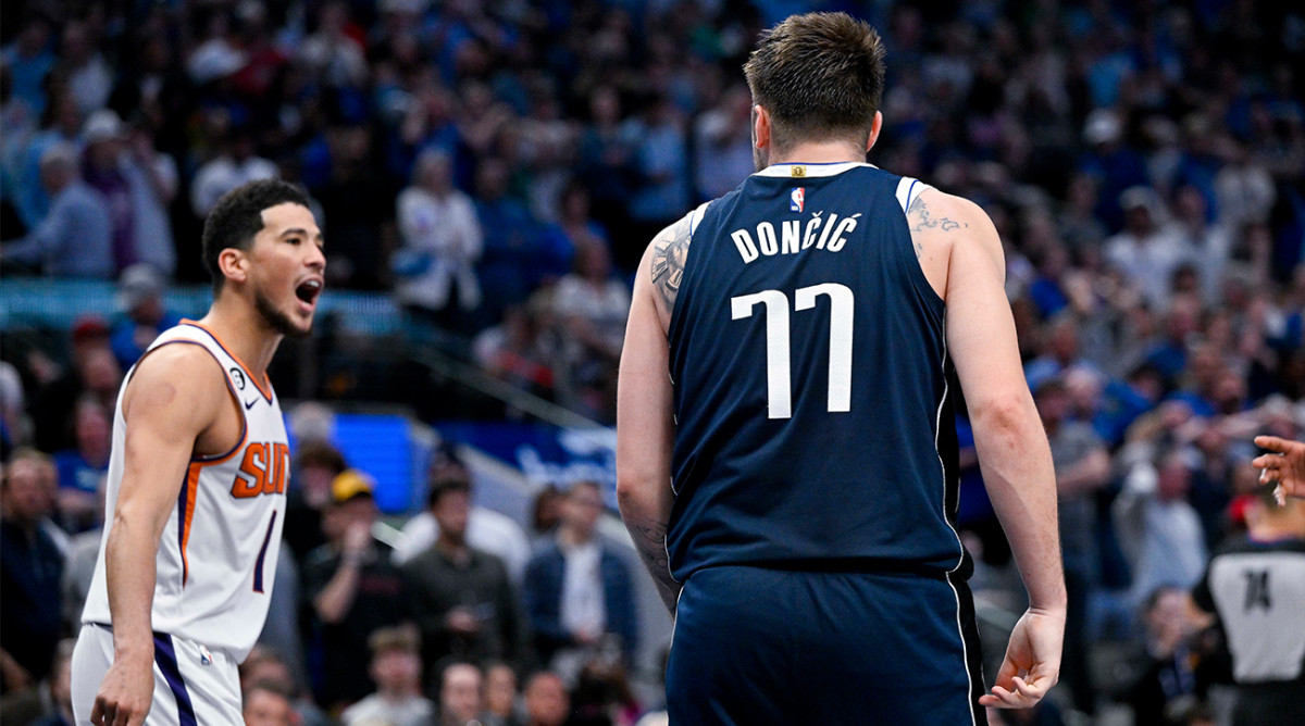Mavericks’ Luka Doncic reacts to Suns’ Devin Booker making a basket.
