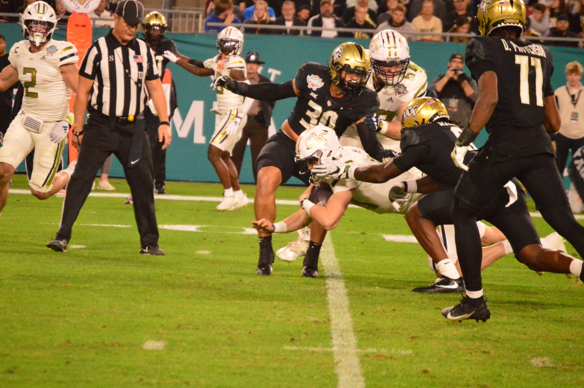 Haynes King being tackled by UCF