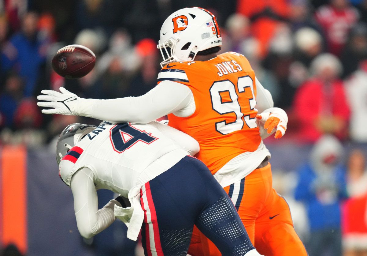 Denver Broncos defensive tackle D.J. Jones (93) sacks New England Patriots quarterback Bailey Zappe (4) in the first quarter at Empower Field at Mile High.