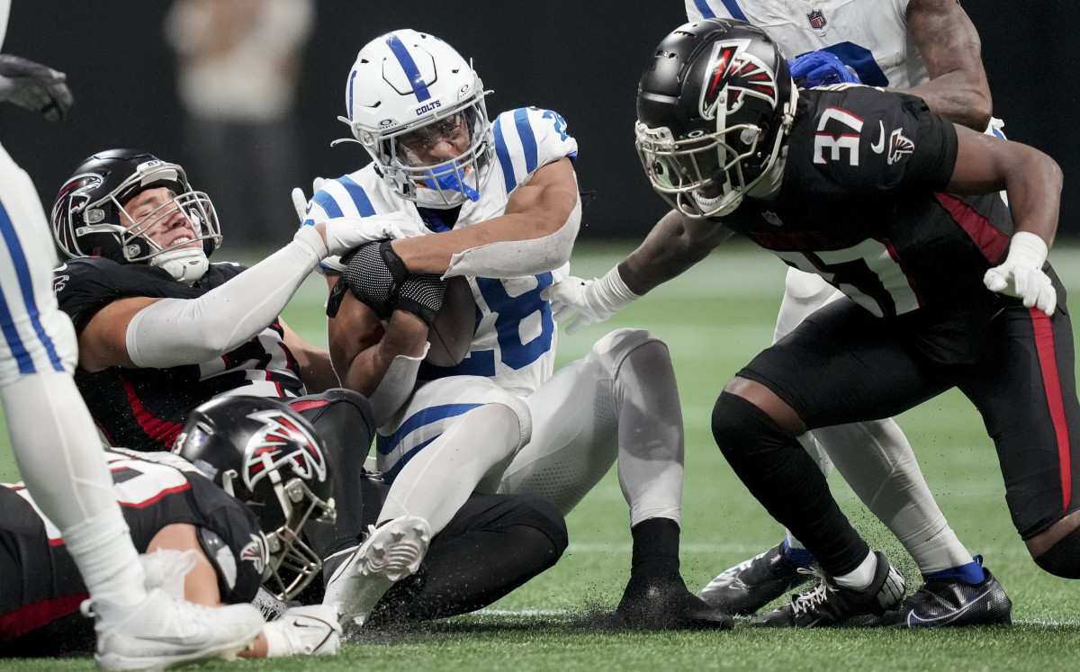 Indianapolis Colts running back Jonathan Taylor (28) is brought down by Atlanta Falcons defenders during a game against at Mercedes-Benz Stadium.