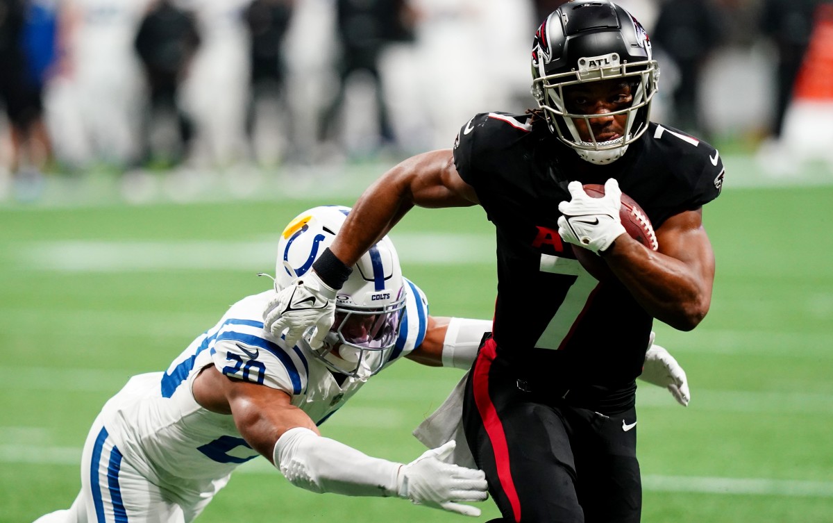 Atlanta Falcons running back Bijan Robinson (7) carries the ball against Indianapolis Colts safety Nick Cross (20) during the first half at Mercedes-Benz Stadium.