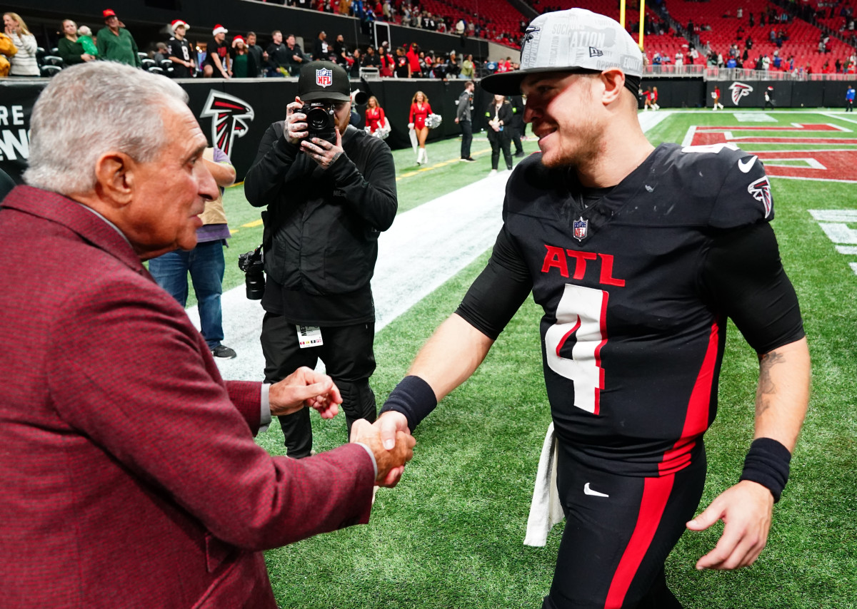 Atlanta Falcons quarterback Taylor Heinicke (4) greets owner Arthur Blank as he walks off the field following the Falcons 29-10 victory over the Indianapolis Colts at Mercedes-Benz Stadium.