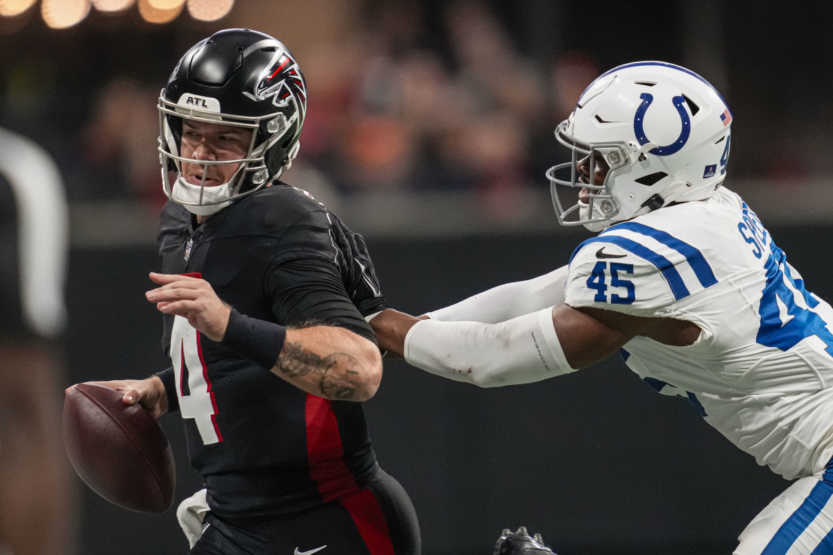 Dec 24, 2023; Atlanta, Georgia, USA; Atlanta Falcons quarterback Taylor Heinicke (4) is pushed out of bounds by Indianapolis Colts linebacker E.J. Speed (45) during the first half at Mercedes-Benz Stadium.
