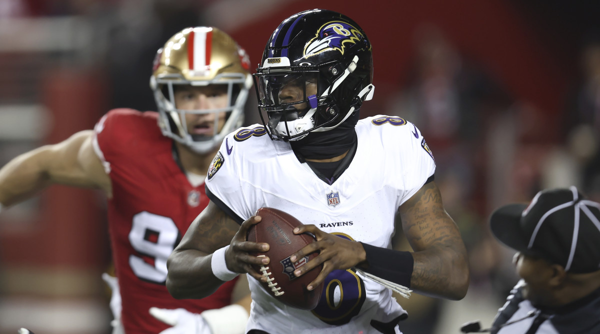Ravens quarterback Lamar Jackson is chased by 49ers defensive end Nick Bosa