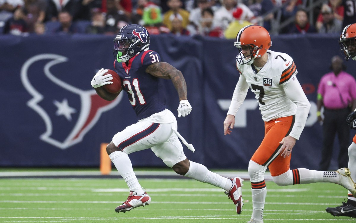 Dec 24, 2023; Houston, Texas, USA; Houston Texans running back Dameon Pierce (31) runs past Cleveland Browns place kicker Dustin Hopkins (7) to score a touchdown on a kickoff return during the second quarter at NRG Stadium. Mandatory Credit: Troy Taormina-USA TODAY Sports