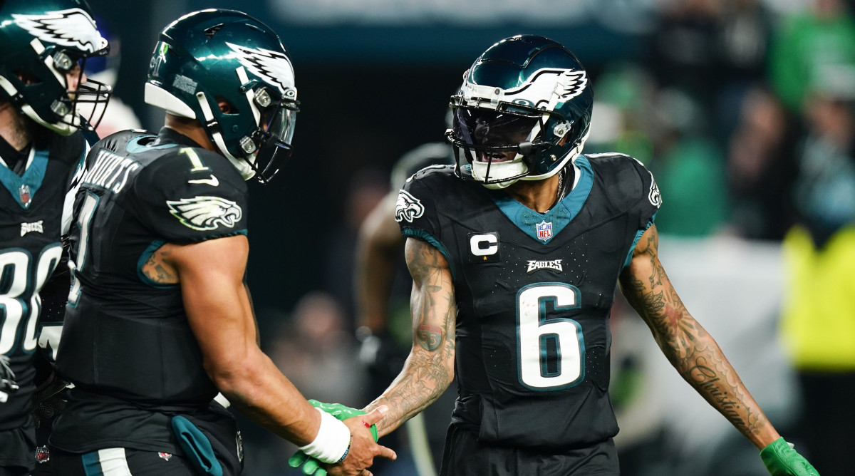 Eagles wide receiver DeVonta Smith, right, celebrates after scoring with quarterback Jalen Hurts on Christmas Day 2023