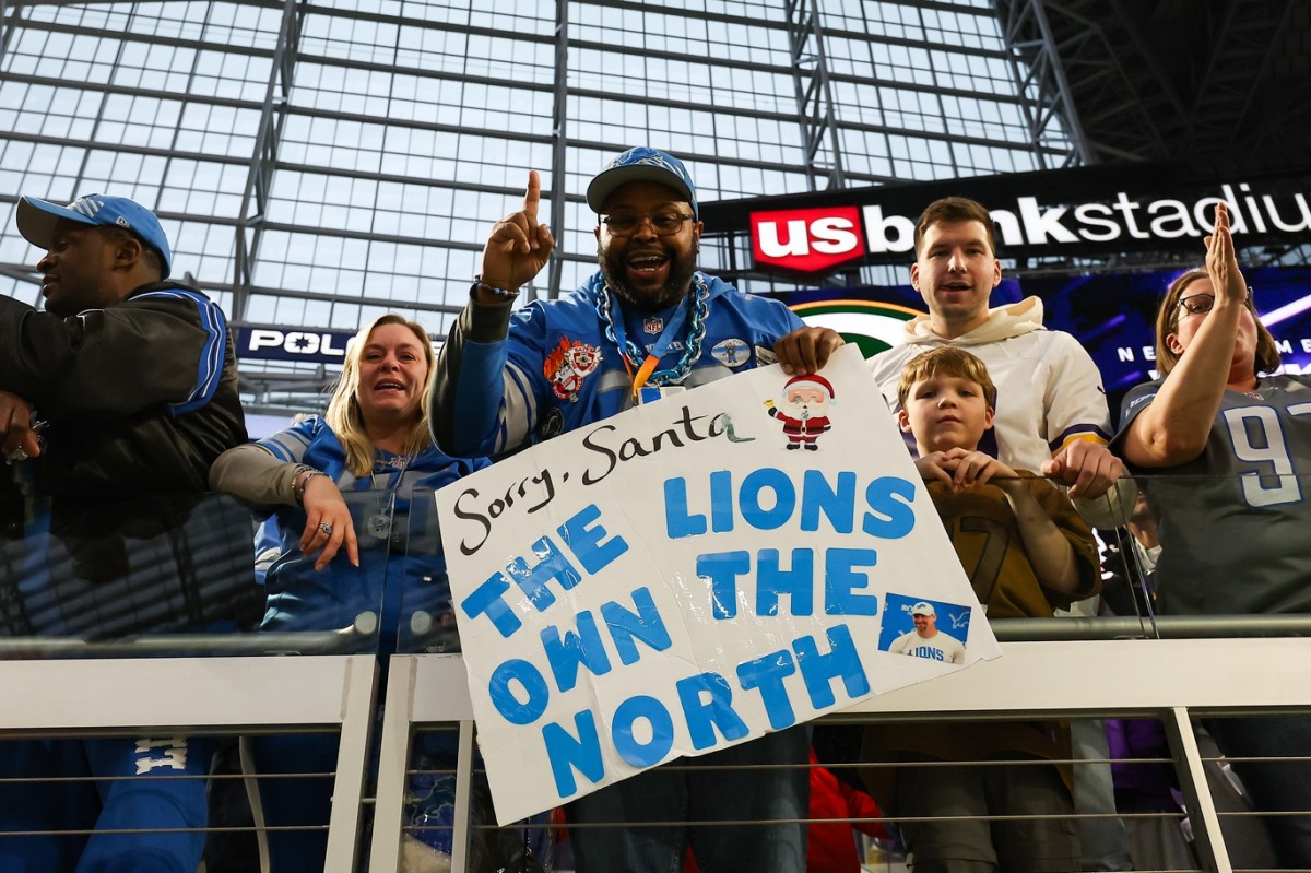 Lions fans celebrate the team's first division title since 1993 after Detroit defeated Minnesota 30-24 Sunday at U.S. Bank Stadium.