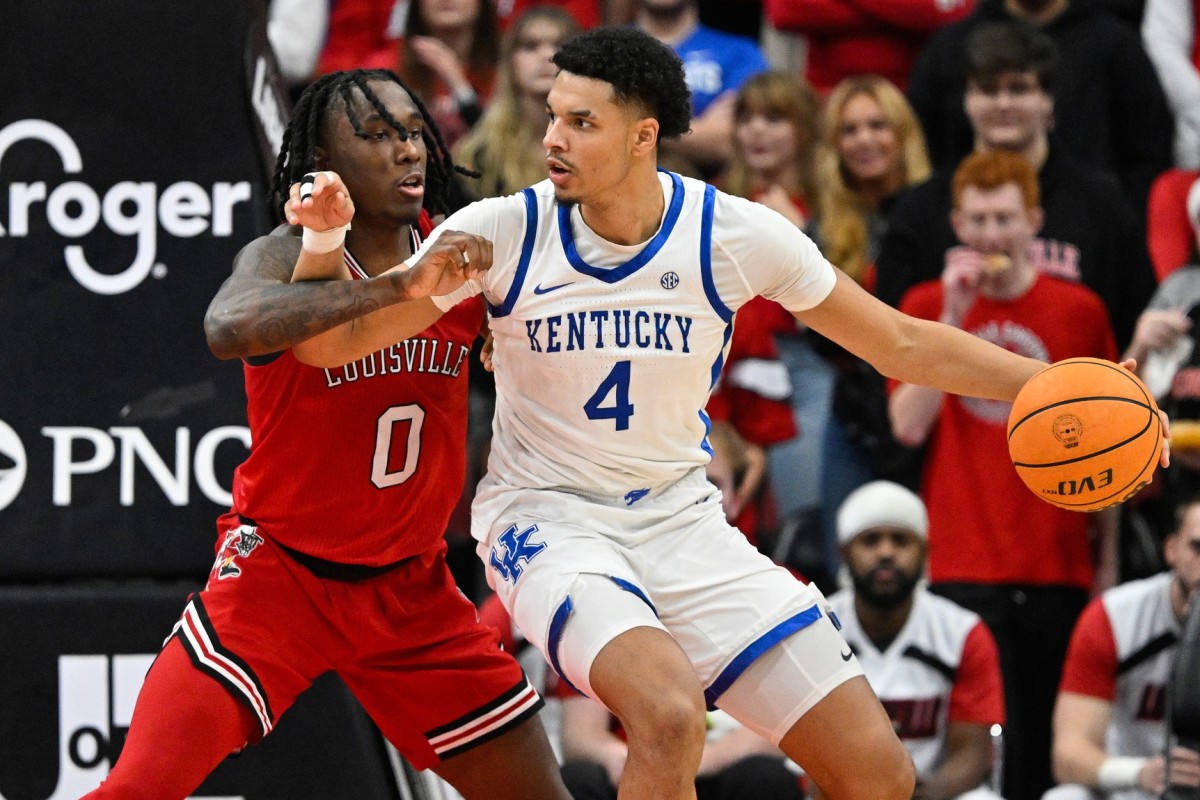Kentucky Wildcats forward Tre Mitchell dribbles against Louisville Cardinals guard Mike James